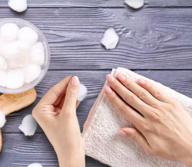 Applying the cotton balls on nails
