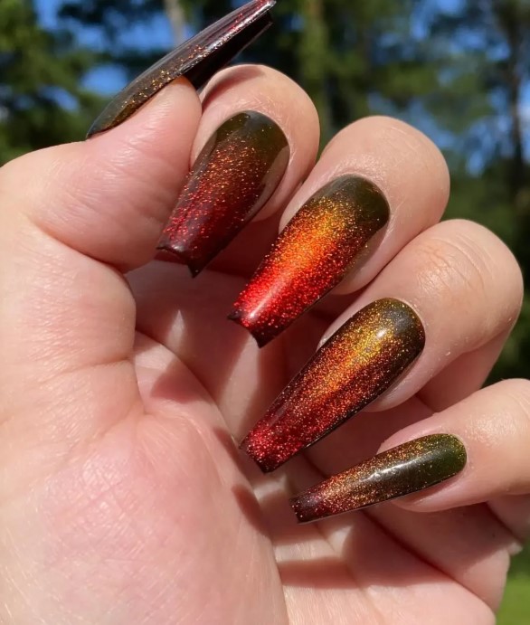 Black Cat Eye Nail Art with Orange and Yellow sparkle