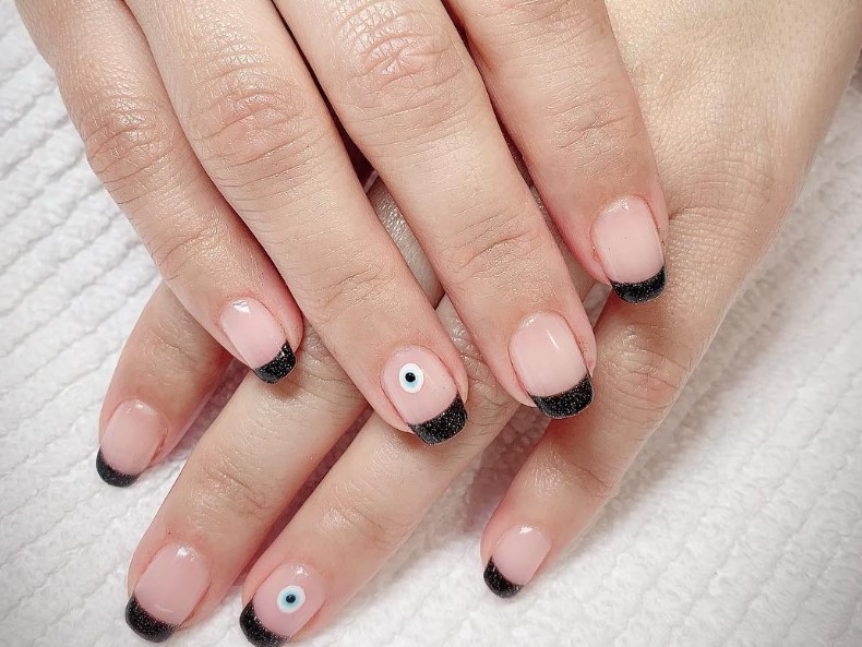 Black French Tips with Evil Eye Nail Art