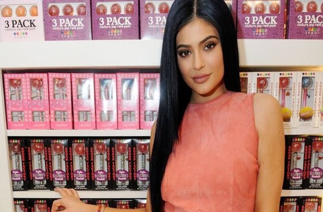 Kylie Jenner posing with her brand products