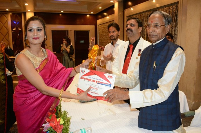 Monica Sinha while receiving an appriciation certificate for her beauty services in Patna