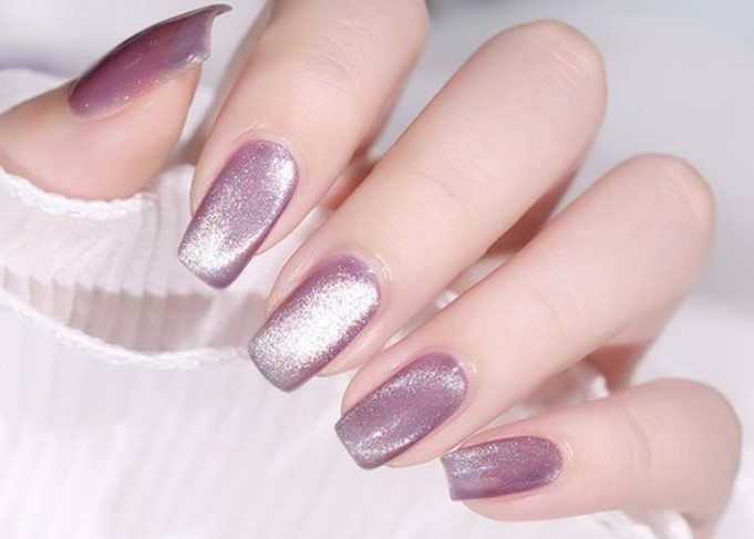 Purple shimmering cat eye nail art